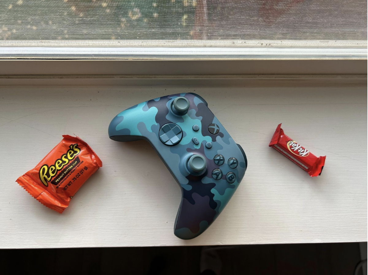 A video game controller sits next to Halloween candy on the 31st of October. 